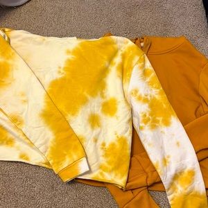 2 womens small cropped hoodies, one gold, one yellow tie dye